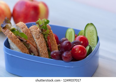 Lunch Box With Sandwich And Fruit.