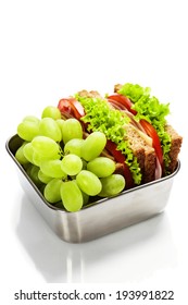 Lunch Box With Sandwich And Grapes On White Background