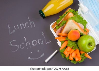 Lunch Box At School And Office On A Dark Background. Chalk Writing Lunch School. Social Distance, Stay Safe. Hygiene And Protection Against Bacteria And Viruses. View From Above. Copy Space