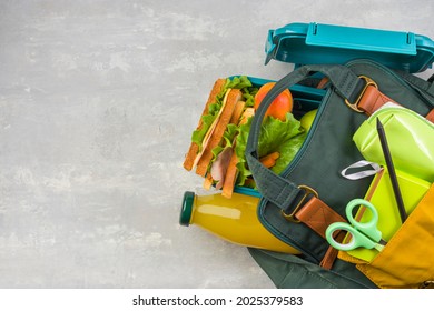 Lunch Box, School And Office Supplies, Medical Face Mask On A Light Background. Back To School Concept. Social Distance, Learning And Home Education. Stay Safe. Top View Copy Space.