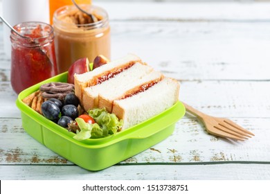 Lunch box set of Peanut butter with strawberry jam sandwich with cracker, apple in box and orange juice. Kid bento pack for school. - Powered by Shutterstock