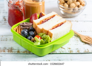 Lunch box set of Peanut butter with strawberry jam sandwich with cracker, apple in box and orange juice. Kid bento pack for school. - Powered by Shutterstock