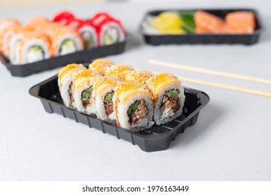 Lunch Boxes With Sushi Set. Assorted Fresh Rolls Philadelphia, California, Sashimi On Light Background. Tasty Vegetarian Lunch.Food Delivery, Takeaway Concept. Japanese Cuisine Seafood. 