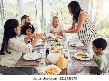 Lunch, eating food and big family in their Mexico home dining room table for summer reunion or quality time together. Puerto Rico mother, grandparents and children with chicken, salad and bread meal - Powered by Shutterstock