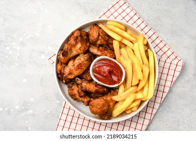 lunch fast food chicken wings with ketchup and potatoes fries - Powered by Shutterstock