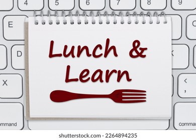 Lunch and Learn message with a fork on a notepad on a computer keyboard