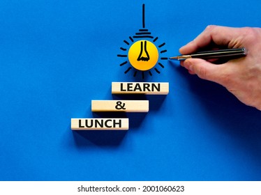 Lunch And Learn Symbol. Wooden Blocks With Concept Words Lunch And Learn. Beautiful Blue Background. Businessman Hand, Light Bulb Icon. Copy Space. Business, Educational And Lunch And Learn Concept.