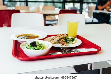 Lunch On Tray In The Cafeteria. Soup, Salad And Fried Meet 