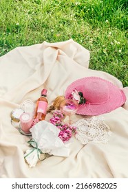 Lunch Picnic In The Park On The Green Grass With Baguette And  Flowers, Wine Bottle And Cheese At Pale Beige Blanket With Sun Hat.  Aesthetic Summertime. Outdoor 