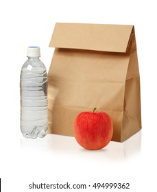 Lunch Time. Closeup Of Brown Paper Lunch Bag,red Apple And Bottle Of Water Isolated On White.