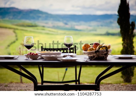 lunch with a view - table against beautiful landscape in Tuscany