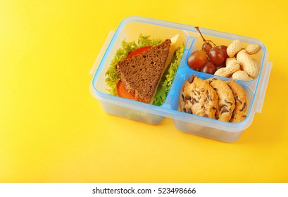 Lunchbox With Dinner On Yellow Background