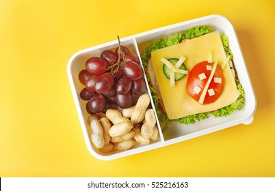 Lunchbox With Dinner On Yellow Background