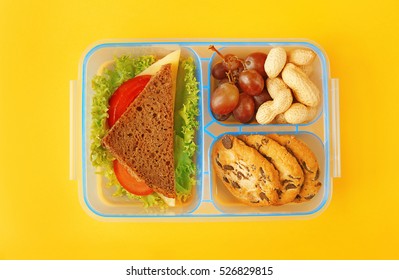 Lunchbox With Dinner On Yellow Background