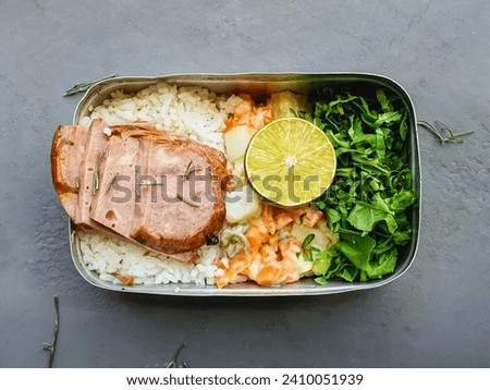 lunchbox in the pot with rice, salad, mayonnaise, and meat and  rustic background