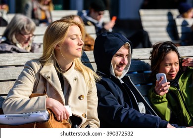 Lund, Sweden - March 12, 2016: Young And Attractive Adult Female Basking In The Fine Spring Sunshine. Real People In Everyday Life.