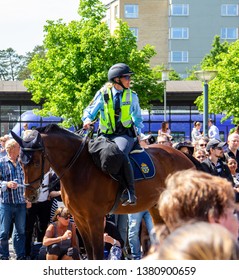 Lund, Skåne, Sweden - May 19 2018: Swedish Equestrian Police Woman Waiting For The Lundakarnevalen Parade To Start. A Parade Where University Students Parade Through The City, Mocking Recent Events.