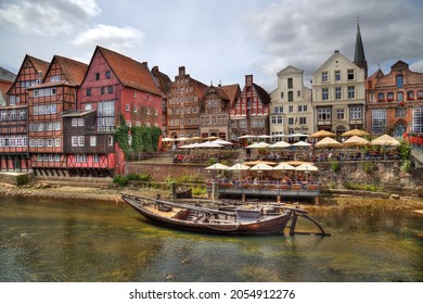 Luneburg, Germany - July 4, 2019: Old Luneburger harbor with traditional houses, restaurants and a historical boat in the old part of Luneburg, Germany on July 4, 2019