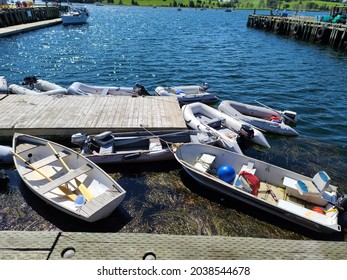 Lunenburg, NS, CAN, September 8, 2021 - A View Along The Harbor In Lunenburg, Nova Scotia. There Are Multiple Row Boats And Inflated Motor Boats Tied To The Tiny Dock.