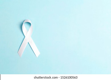 Lung cancer awareness ribbon on blue background. November lung cancer awareness month.