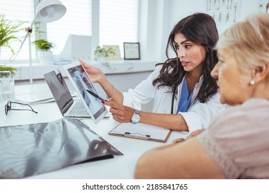 Lung cancer concept. Doctor explaining results of lung check up from x-ray scan chest on digital tablet screen to patient. The doctor is analyzing and clarifying images of the patient's lung X-rays. - Powered by Shutterstock