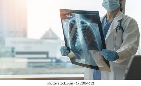 Lung disease, covid-19, asthma or bone cancer illness with doctor diagnosing patient’s health on radiological chest x-ray film for medical healthcare hospital service - Shutterstock ID 1951064632