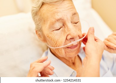 Lung Patient Senior With Oxygen Glasses In Respiratory Therapy In Nursing