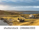 Lunna Kirk, ruin of old fishing booth and 18th century Lunna Kirk at East Lunna Voe, Lunna Ness, United Kingdom, Scotland, Shetland Islands, Mainland