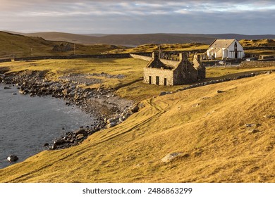 Lunna Kirk, ruin of old fishing booth and 18th century Lunna Kirk at East Lunna Voe, Lunna Ness, United Kingdom, Scotland, Shetland Islands, Mainland - Powered by Shutterstock