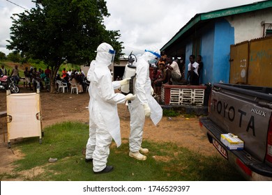 Lunsar, Sierra Leone - July 8, 2015: Buerial Team Members Ready To Take A Body In A Village. Ebola Response Epidemic Disease In Africa, Ebola And Corona Virus Context