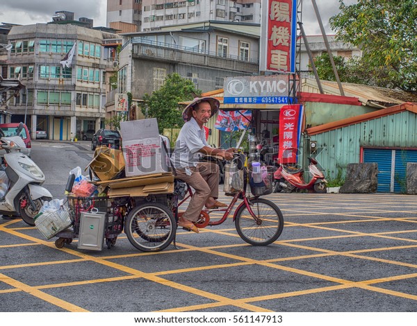 Luodong, Taiwan\
- October 18, 2016: Taiwanese man carrying different items on a\
three-wheeled bicycle. Tricycles  are  very popular means of\
transportation for older people in\
Taiwan
