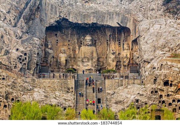 LUOYANG, CHINA -MAR 19: Visitors at\
Longmen grottoes on March 19, 2014.It is one of the four notable\
grottoes in Luoyang,Henan,China . A UNESCO World Heritage Site.\
