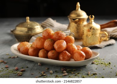 luqaimat or lokma. Freshly fried Lokma (luqma - arabic) piled high a popular middle eastern dessert of small dough balls deep fried then coated in sugar or honey syrup