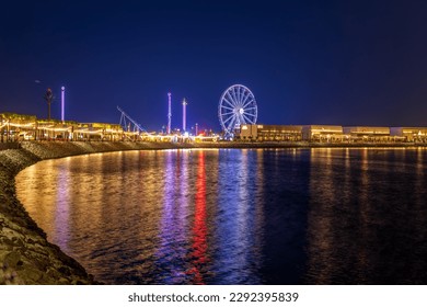 Lusail, Qatar - April 10, 2023: Ferris wheel, Lusail Winter Wonderland outdoor amusement park in Al Maha Island Night View - Shutterstock ID 2292395839