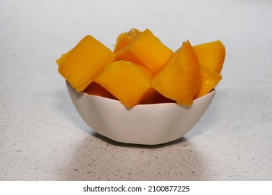 luscious fresh cut mango in a white dish