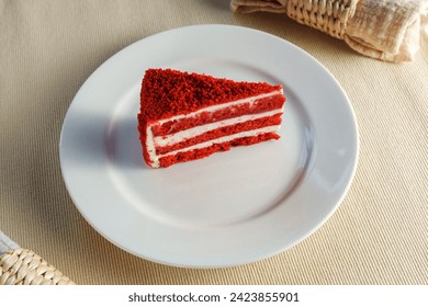 Luscious Indulgence: A Tempting Slice of Red Velvet Cake on a Delicate White Plate