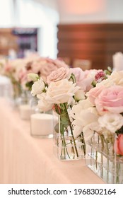 Lush floral arrangement of white and pink fresh flowers and greenery on wedding table for newlyweds. Beautiful flowers on table with white cloth, free space. Luxury wedding table decorations - Shutterstock ID 1968302164