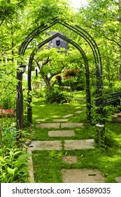 Lush Green Garden With Wrought Iron Arbor