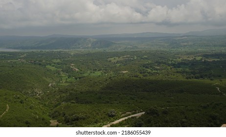 Lush Green Hills With Beautiful Clouds In The Backdrop