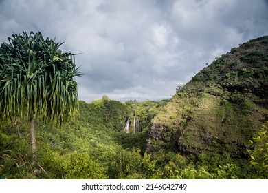 Lush Green Hillside With Waterfall