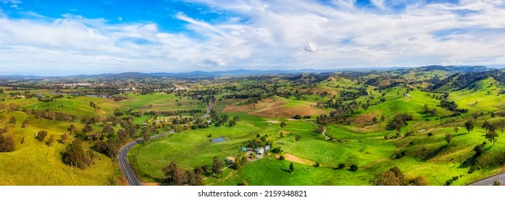 Lush green pastures in wide aerial panorama of Bega Valley meadows on dairy farms, Australian agriculture.