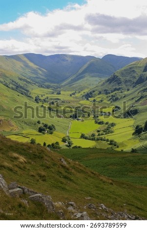 A lush green valley with a patchwork of rolling hills and lush grassy fields.