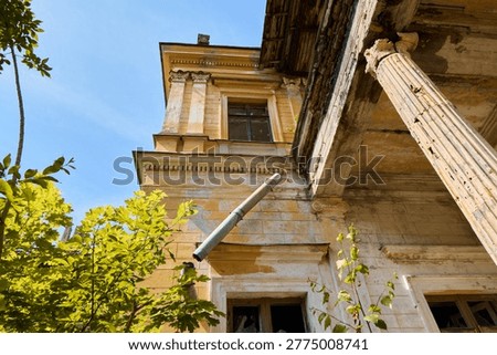 Lush greenery and decayed structures beneath bright blue sky