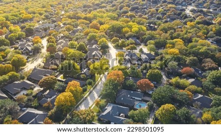Lush greenery master planned community subdivision colorful fall leaves and row of single-family homes with swimming pool in upscale neighborhood Dallas, North Texas, USA. Aerial view subdivision
