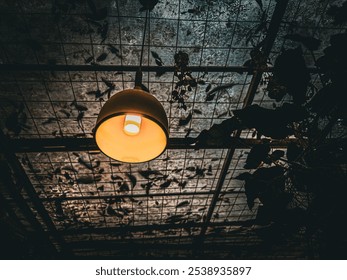 Lush greenery with modern yellow pendant lights in a botanical setting - Powered by Shutterstock