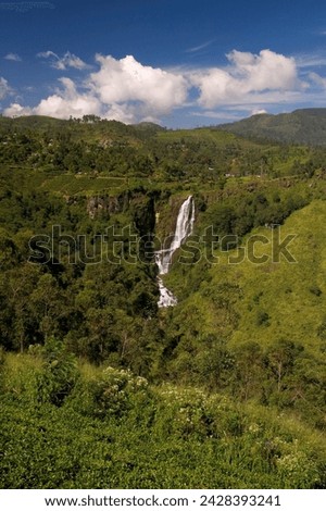 Lush highland countryside and waterfall in the hill country around nuwara eliya, sri lanka, asia