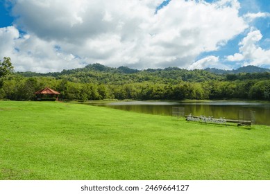 Lush parkland featuring a visitor center. Lakeside camping at Jedkod Pongkonsao Natural Study and Ecotourism Center Saraburi Thailand. Camping trip tent on morning. Adventures Camping tourism and tent - Powered by Shutterstock