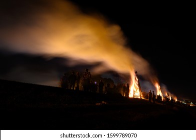 Lutcher, LA / United States - 12 24 2019: Annual Christmas Bonfires A Cajun Tradition Along Mississippi River Levee Guiding Papa Noel