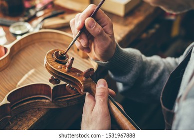 Luthier repair violin in his workshop