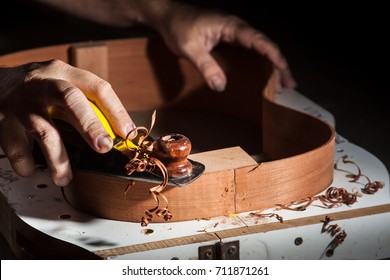 Luthier working on guitar under construction
